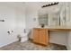 Bathroom with a vanity, large mirror, tile flooring, toilet, and minimal decor at 7011 Overton St, Las Vegas, NV 89166