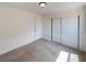 Bright bedroom features neutral carpet, white walls, ceiling light fixture and closet with sliding doors at 7011 Overton St, Las Vegas, NV 89166