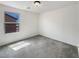 Bright bedroom featuring neutral carpet and a window overlooking the side yard at 7011 Overton St, Las Vegas, NV 89166