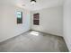 Clean bedroom with two windows, neutral carpet, and fresh paint at 7011 Overton St, Las Vegas, NV 89166