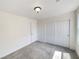 Bright bedroom features neutral carpet, white walls, ceiling light fixture and closet with sliding doors at 7011 Overton St, Las Vegas, NV 89166