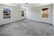 Spacious, bright bedroom with neutral carpet, white walls and multiple windows for ample natural light at 7011 Overton St, Las Vegas, NV 89166