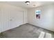 Bright bedroom with neutral carpet, closet doors, and a large window at 7011 Overton St, Las Vegas, NV 89166