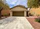 Charming single-story home with a two-car garage, low maintenance landscaping, and a covered entryway at 7011 Overton St, Las Vegas, NV 89166