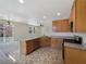 Bright kitchen with light wood cabinetry, stainless steel appliances, and an open layout to the living area at 7011 Overton St, Las Vegas, NV 89166