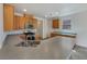 Spacious kitchen with light wood cabinets, stainless steel appliances, and a large island with a sink at 7011 Overton St, Las Vegas, NV 89166