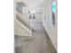 Carpeted living space featuring an open staircase and neutral paint at 7011 Overton St, Las Vegas, NV 89166