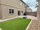 Private backyard featuring low-maintenance artificial turf, brick-paved patio, and a basketball hoop for recreation at 7041 Fossil Rim St, North Las Vegas, NV 89084