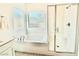 Bathroom with a soaking tub and tiled shower at 7041 Fossil Rim St, North Las Vegas, NV 89084