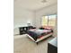 Comfortable bedroom with a bright window, showcasing natural light and a cozy space at 7041 Fossil Rim St, North Las Vegas, NV 89084