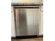 Modern stainless steel dishwasher installed among white kitchen cabinets at 7041 Fossil Rim St, North Las Vegas, NV 89084