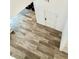 Entry way features wood-look flooring and leads to the front door at 7041 Fossil Rim St, North Las Vegas, NV 89084