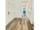 Inviting hallway featuring stylish laminate flooring and neutral wall paint at 7041 Fossil Rim St, North Las Vegas, NV 89084