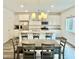 Bright kitchen with white cabinets, stainless steel appliances, granite counters, and island seating at 7041 Fossil Rim St, North Las Vegas, NV 89084