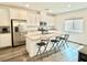 Bright kitchen featuring a granite island with bar stool seating and stainless steel appliances at 7041 Fossil Rim St, North Las Vegas, NV 89084