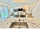 Inviting open concept featuring a modern kitchen, dining area, and comfortable living room with abundant natural light at 7041 Fossil Rim St, North Las Vegas, NV 89084