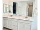 Bright bathroom featuring double sinks and vanity with white countertops at 7041 Fossil Rim St, North Las Vegas, NV 89084