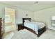 Comfortable main bedroom with neutral carpet and ensuite bath access at 7041 Fossil Rim St, North Las Vegas, NV 89084