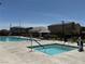 Community pool and spa with surrounding lounge area for relaxing at 7041 Fossil Rim St, North Las Vegas, NV 89084