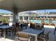 Covered patio area featuring tables and chairs for residents near the community pool at 7041 Fossil Rim St, North Las Vegas, NV 89084