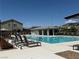 Community pool with lounge chairs and a clear blue pool at 7041 Fossil Rim St, North Las Vegas, NV 89084