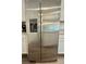 Stainless steel refrigerator with water and ice dispenser, fitting seamlessly into the kitchen at 7041 Fossil Rim St, North Las Vegas, NV 89084