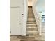 Carpeted staircase leading to the upper level of a well-lit home at 7041 Fossil Rim St, North Las Vegas, NV 89084