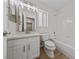 Bright bathroom with white vanity, mirror and a shower over bath combo at 7441 Aurora Glow St, Las Vegas, NV 89139