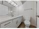 White bathroom with a large mirror, new lights and a modern white vanity at 7441 Aurora Glow St, Las Vegas, NV 89139
