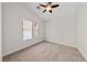 Clean and simple bedroom featuring neutral carpet, light walls, and a window at 7441 Aurora Glow St, Las Vegas, NV 89139