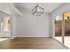Bright dining room with modern light fixture and sliding glass door at 7441 Aurora Glow St, Las Vegas, NV 89139
