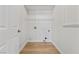 A clean, white laundry room featuring new paint, tile flooring and all connections at 7441 Aurora Glow St, Las Vegas, NV 89139