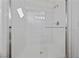All-white shower stall with glass door, chrome fixtures and an adjustable shower head at 7441 Aurora Glow St, Las Vegas, NV 89139