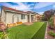 This well-manicured backyard features artificial turf, brick pavers, and desert landscaping, a true oasis at 7716 Twin Tails St, Las Vegas, NV 89149