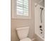 Bright bathroom featuring a shower-tub combination, toilet, and natural light from the window at 7716 Twin Tails St, Las Vegas, NV 89149
