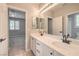 Bathroom with double sink vanity and mirrored wall at 7716 Twin Tails St, Las Vegas, NV 89149