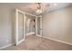 Neutral bedroom with ceiling fan and glass french doors to other rooms at 7716 Twin Tails St, Las Vegas, NV 89149