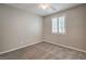 Cozy bedroom with soft carpet, neutral walls, a ceiling fan, and bright window at 7716 Twin Tails St, Las Vegas, NV 89149