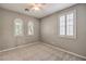 Bedroom with soft carpet, neutral walls, ceiling fan, and arched windows at 7716 Twin Tails St, Las Vegas, NV 89149
