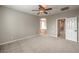 Spacious bedroom with neutral walls, ceiling fan, and ensuite bathroom at 7716 Twin Tails St, Las Vegas, NV 89149