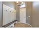 View of an entryway featuring an coat rack, a bench, a chandelier, and tile flooring at 7716 Twin Tails St, Las Vegas, NV 89149