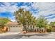 Inviting single-story home with a two-car garage, mature landscaping, and a well-maintained front yard at 7716 Twin Tails St, Las Vegas, NV 89149