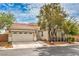 Charming single-story home featuring a two-car garage, desert landscaping, and a red tile roof at 7716 Twin Tails St, Las Vegas, NV 89149