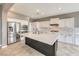 Close-up of a kitchen with white cabinets, stainless appliances, and a dark island at 7716 Twin Tails St, Las Vegas, NV 89149