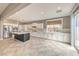 Spacious open kitchen with an island, stainless steel appliances, and backyard access at 7716 Twin Tails St, Las Vegas, NV 89149