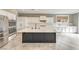 Modern kitchen with a center island, stainless steel appliances, and a bright window at 7716 Twin Tails St, Las Vegas, NV 89149