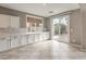Bright kitchen with long counter, subway tile backsplash, and view of landscaped backyard at 7716 Twin Tails St, Las Vegas, NV 89149