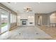 Living room featuring recessed lighting, tile floors, a fireplace, sliding glass doors, and neutral paint at 7716 Twin Tails St, Las Vegas, NV 89149