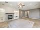 Bright living room featuring a tile floor, a fireplace with shelving, and recessed lighting at 7716 Twin Tails St, Las Vegas, NV 89149