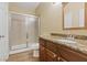 Bathroom featuring a shower, vanity with granite countertops, and wood cabinets at 7808 Brook Valley Dr, Las Vegas, NV 89123